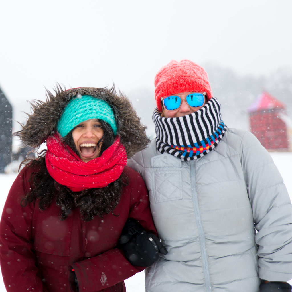 2 people bundled up in winter gear in the snow