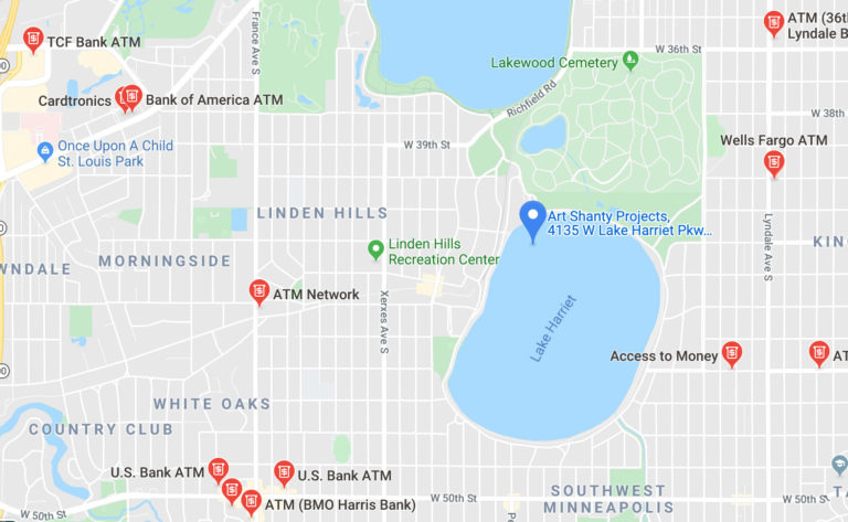 A screen shot of a map, depicting the location of the Art Shanty Projects. A blue marker indicates Art Shanty Projects on the northwestern part of Lake Harriet (Bde Unma). There are also red markers indicating ATMs and banks.