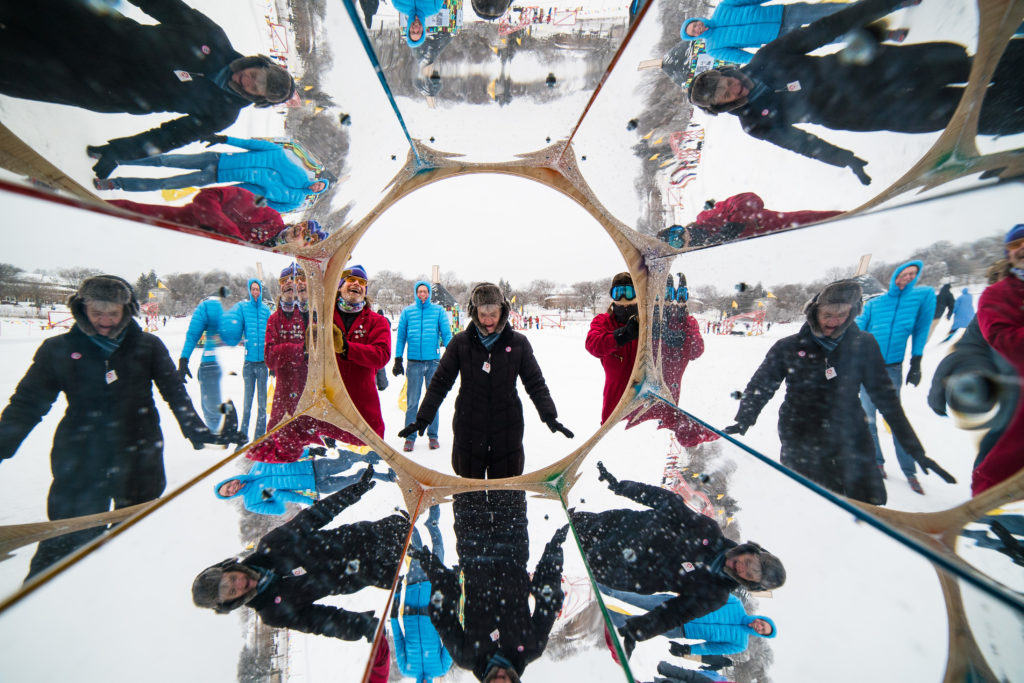 a dizzying view from inside the giant kaleidoscope! There are 8 reflections of the person standing in the middle.