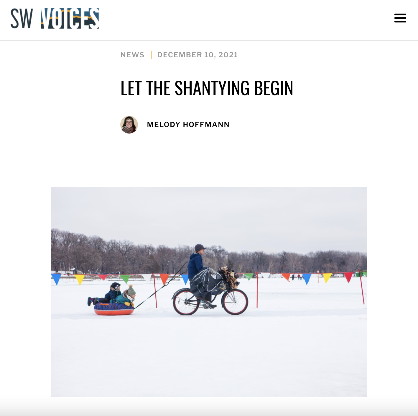 A screenshot of an online article with am image of a bike riding across the frozen lake pulling a sled
