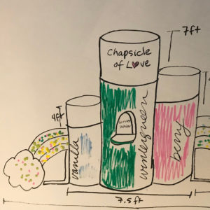 A drawing of a chapel shaped like chapstick tubes with a rainbow holding up one side.