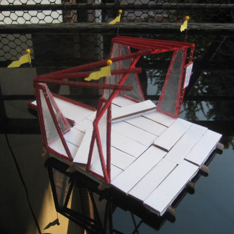 a model of a red and white stage with yellow flags on the top