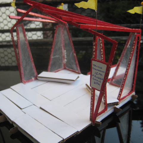 A side view of a stage model that shows a board where daily performances can be written