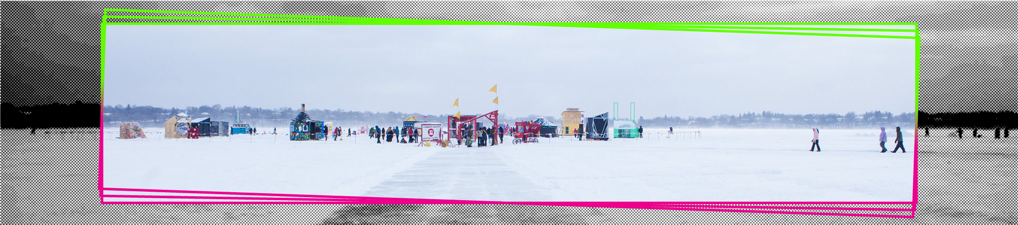 A picture of a frozen lake with an art shanty village in the distance.