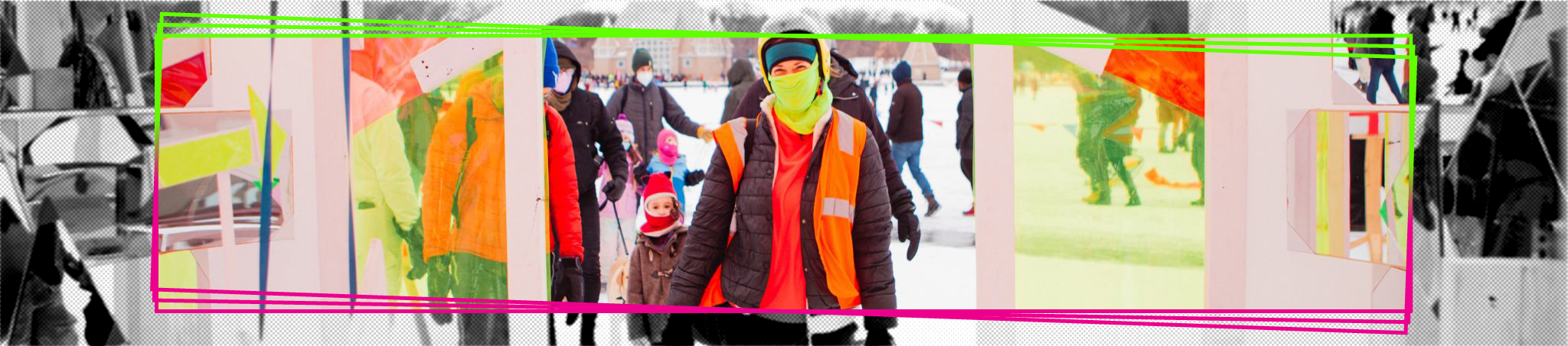 A smiling person in a safety vest and mask looks through a yellow paned window.