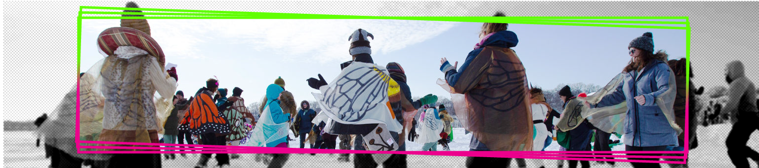 A group of people dressed in butterfly costumes dancing in a circle