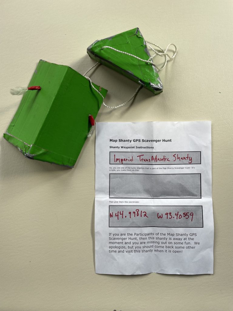 a green geocache pod with a paper reading 'imperial transatlantic shanty'