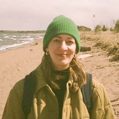 Katie Ortman wearing a beanie while standing on a beach