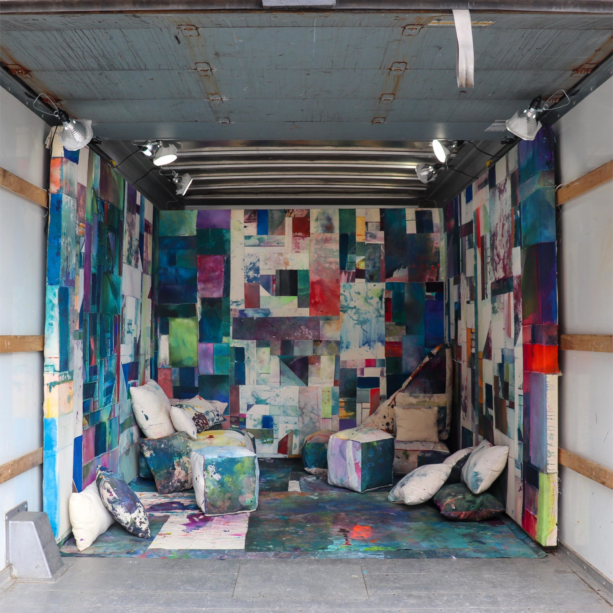 a colorful quilt installation with places to lounge built into the soft structure