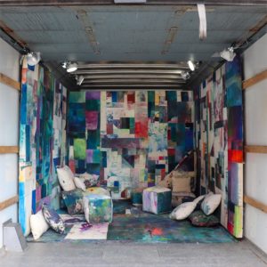 a colorful quilt installation with places to lounge built into the soft structure