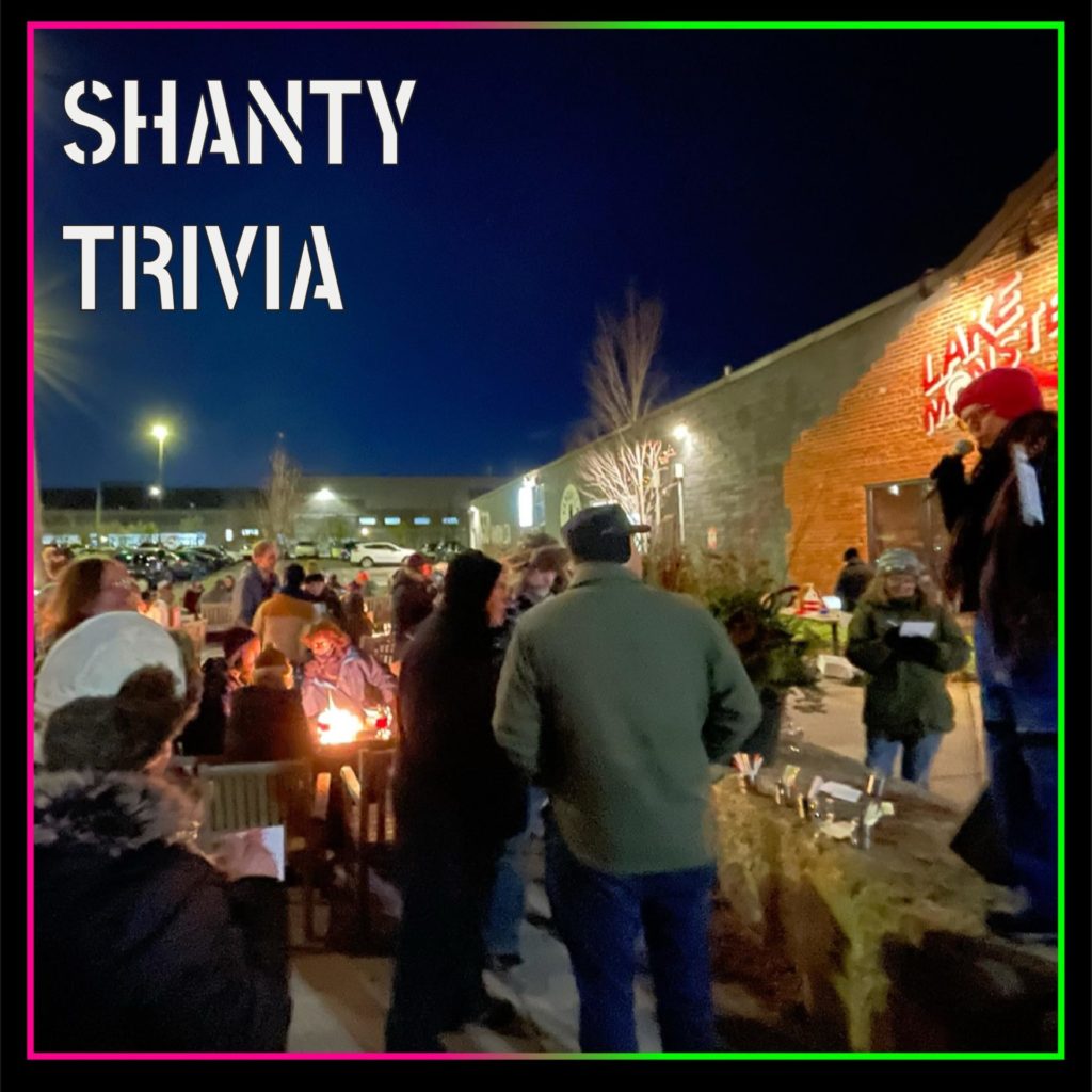 a host leads trivia outside against the dark blue sky