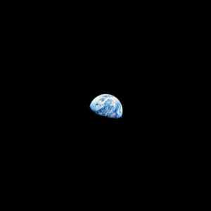 a portion of the earth breaks through the complete darkness of space
