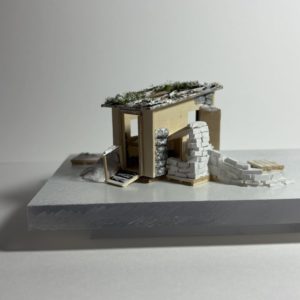 a model of a shanty with piles of snow next to it