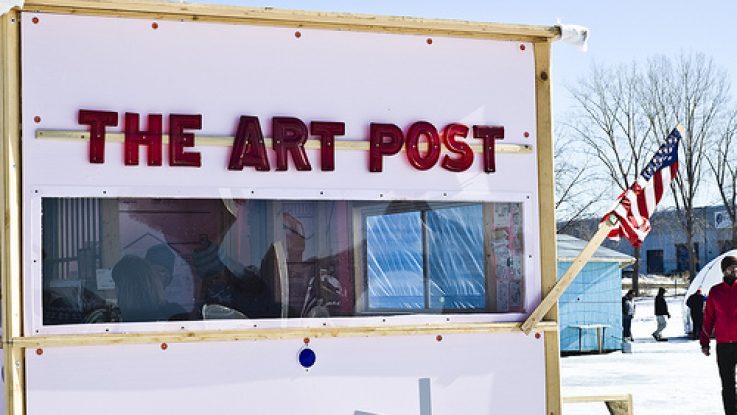 a white shanty labeled "THE ART POST"